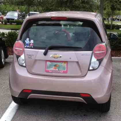 The rear view of a pink Chevrolet Spark
