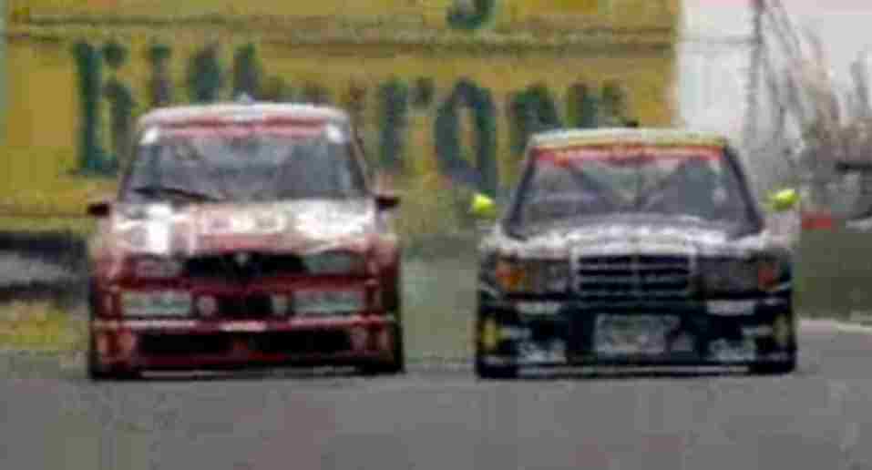 An Alfa-Romeo 155 touring car racing a Mercedes-Benz touring car.