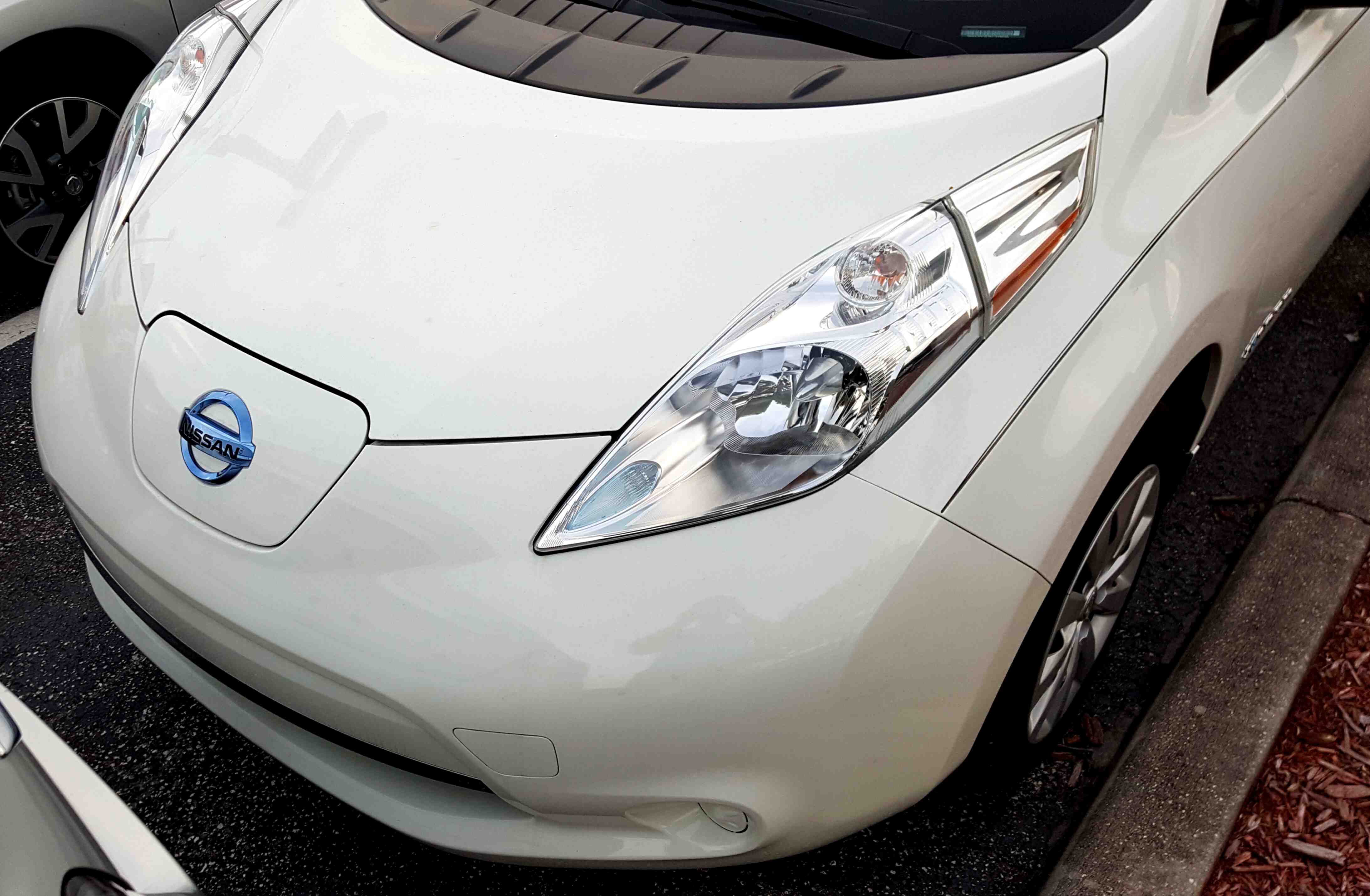 A front view of an arctic white 2015 Nissan Leaf.