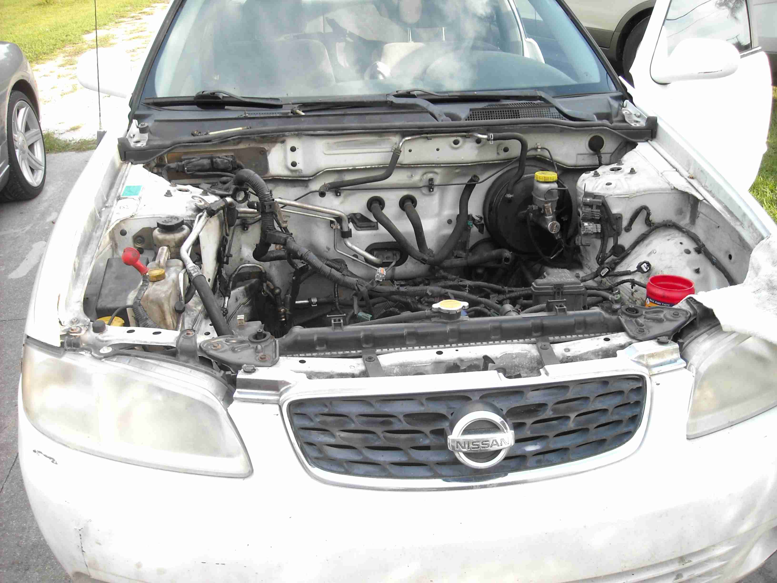A white Nissan Sentra without an Engine