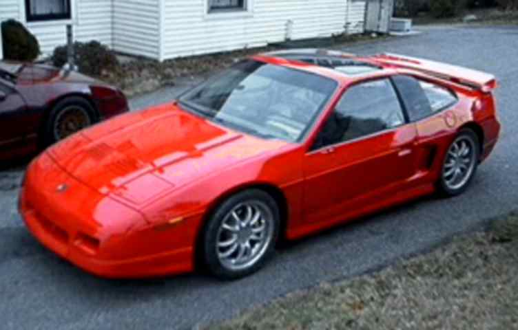 A modified red Pontiac Fiero GT.