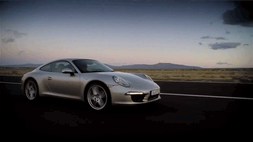 A silver 2012 Porsche 911 driving. (Animated GIF)