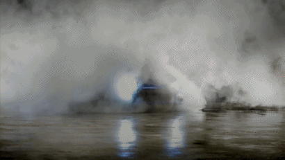 A blue Subaru BRZ drifting through some smoke. Animated GIF Image.